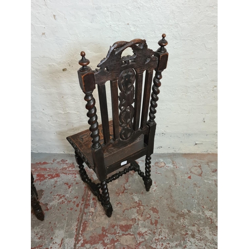 373 - A pair of 19th century heavily carved oak dining chairs with barley twist columns and floral design ... 