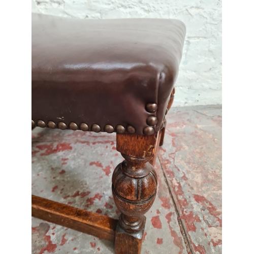 375 - A Cromwellian style oak and brown leatherette stool with brass studding and baluster supports - appr... 