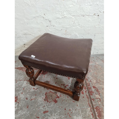 375 - A Cromwellian style oak and brown leatherette stool with brass studding and baluster supports - appr... 