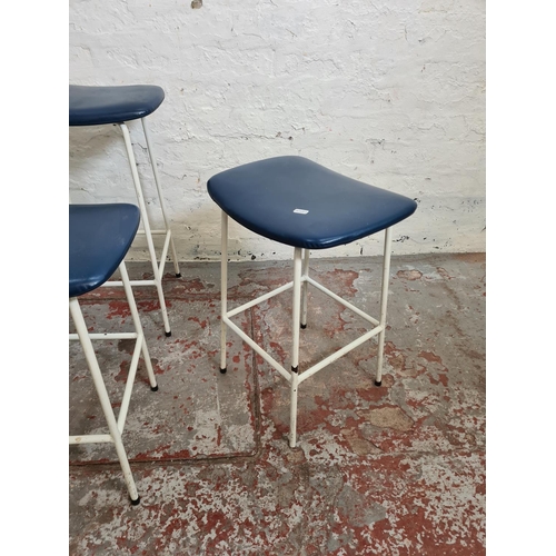 391 - Four 1950s Kandya white tubular metal and blue vinyl stools designed by Frank Guille - three approx.... 