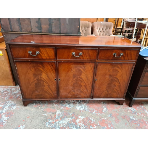 394 - A mahogany sideboard with three drawers and three lower cupboard doors - approx. 85cm high x 137cm w... 