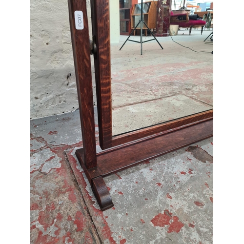 398A - An early 20th century Heal & Co. oak framed swinging dressing table mirror - approx. 55cm high x 66c... 