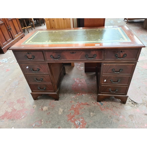 399 - A 19th century style mahogany pedestal desk with eight drawers and green leather writing surface - a... 