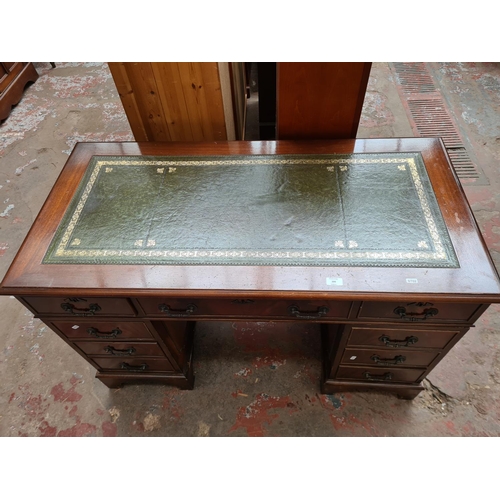 399 - A 19th century style mahogany pedestal desk with eight drawers and green leather writing surface - a... 