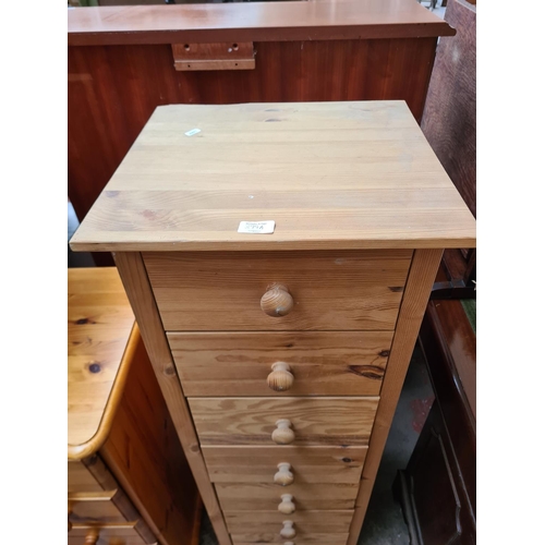 399A - A modern pine chest of seven drawers - approx. 126cm high x 43cm wide x 40cm deep