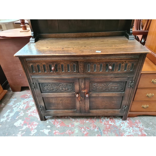 402 - An Arighi Bianchi oak dresser with upper two tier plate rack, two drawers, two lower cupboard doors ... 