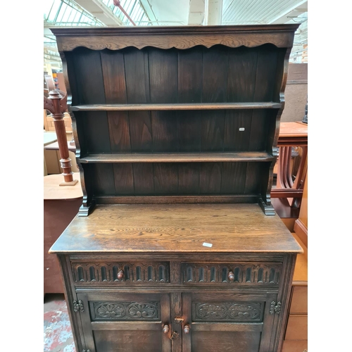 402 - An Arighi Bianchi oak dresser with upper two tier plate rack, two drawers, two lower cupboard doors ... 