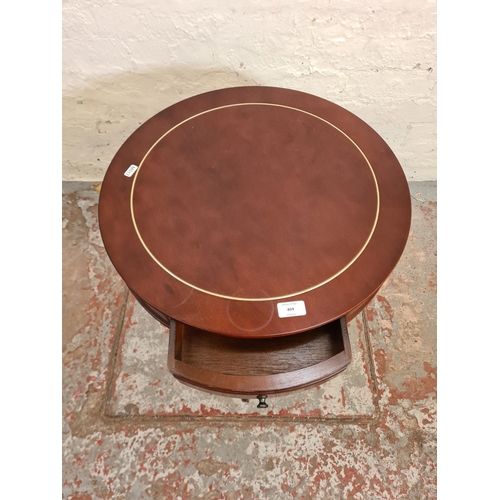 404 - A Regency style mahogany drum table with three drawers - approx. 61cm high x 51cm in diameter