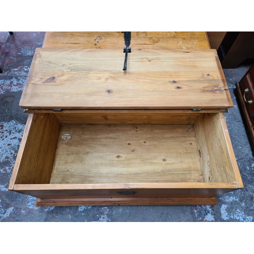 405 - A modern pine square storage coffee table with two hinged lids and cast iron fittings - approx. 42cm... 