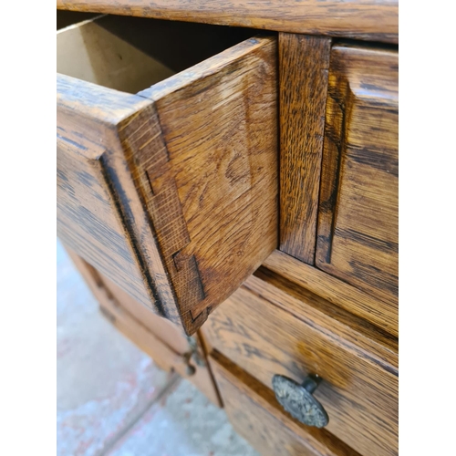 411 - An oak sideboard with two short drawers, two long drawers, carved panel cupboard door and cabriole s... 