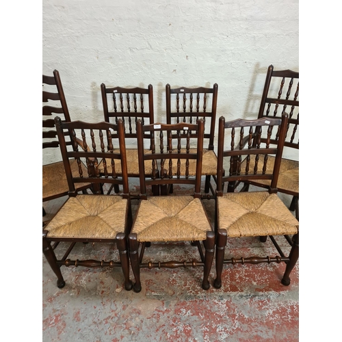 413 - Seven 19th century style oak and rush seated spindle back dining chairs