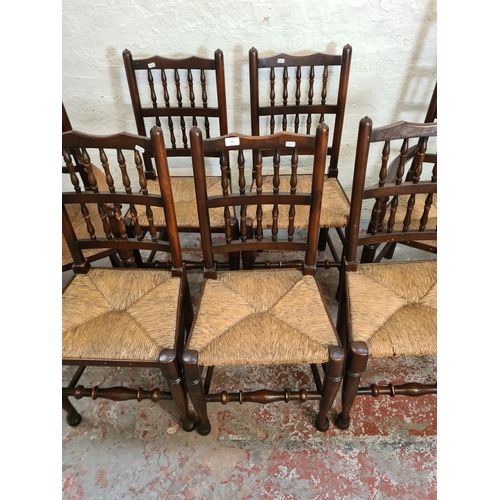 413 - Seven 19th century style oak and rush seated spindle back dining chairs