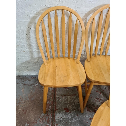 416 - Four modern beech spindle back dining chairs