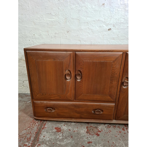 301A - An Ercol Windsor elm sideboard - approx. 64cm high x 104cm wide x 44cm deep