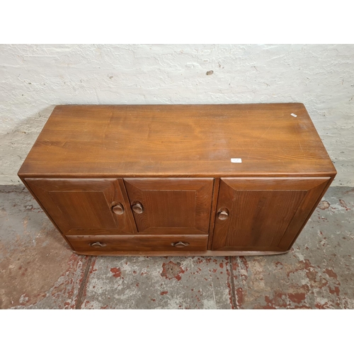 301A - An Ercol Windsor elm sideboard - approx. 64cm high x 104cm wide x 44cm deep