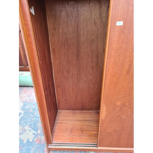 305 - An Austinsuite teak double wardrobe - approx. 70cm high x 121cm wide x 65cm deep