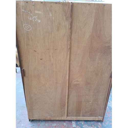 305 - An Austinsuite teak double wardrobe - approx. 70cm high x 121cm wide x 65cm deep