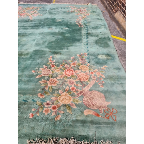 307 - A large green floral patterned rug - approx. 336cm x 460cm