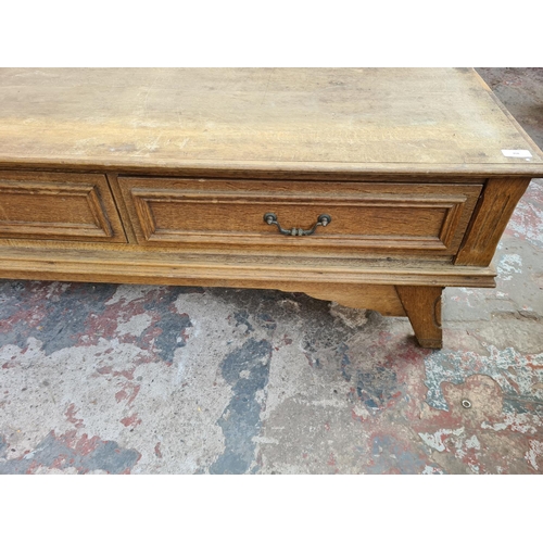 308 - A large modern oak media stand with four drawers - approx. 43cm high x 241cm wide x 52cm deep