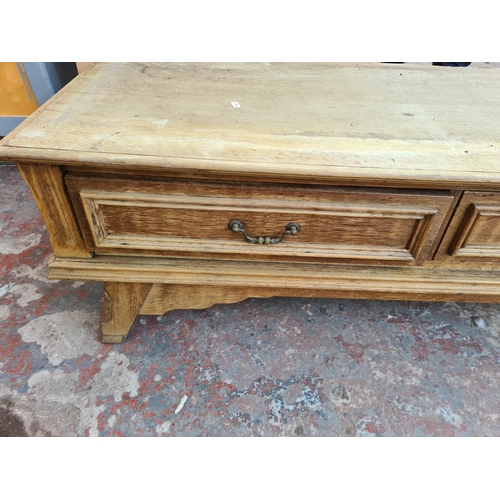 308 - A large modern oak media stand with four drawers - approx. 43cm high x 241cm wide x 52cm deep