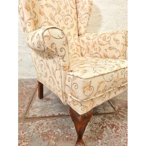 292 - A Plumbs floral upholstered wing back armchair with cabriole supports - approx. 102cm high x 77cm wi... 