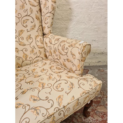 292 - A Plumbs floral upholstered wing back armchair with cabriole supports - approx. 102cm high x 77cm wi... 