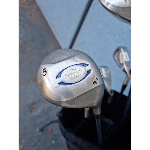 643 - A Memphis golf bag containing Forgan 1860 2000 drivers, SWB99 irons and Yasuda YST-50 putter