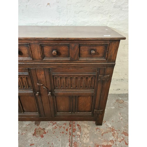 291 - A mid/late 20th century oak sideboard with two drawers and two cupboard doors - approx. 84cm high x ... 