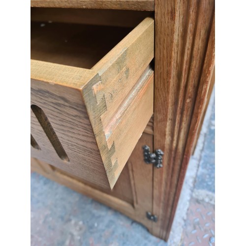 293 - An Agincourt oak dresser with two upper leaded glass doors, two drawers and two lower cupboard doors... 