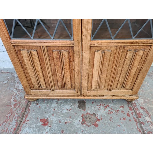 294 - An oak linenfold two door glazed bookcase, originally from Arighi Bianchi - approx. 132cm high x 80c... 