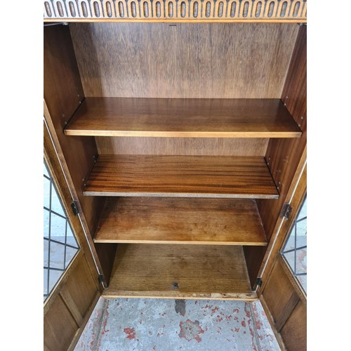 294 - An oak linenfold two door glazed bookcase, originally from Arighi Bianchi - approx. 132cm high x 80c... 