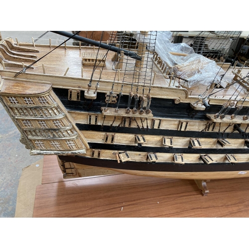 105A - A large scratch built wooden three mast model of The Victory ship on plinth - approx. 150cm high x 2... 
