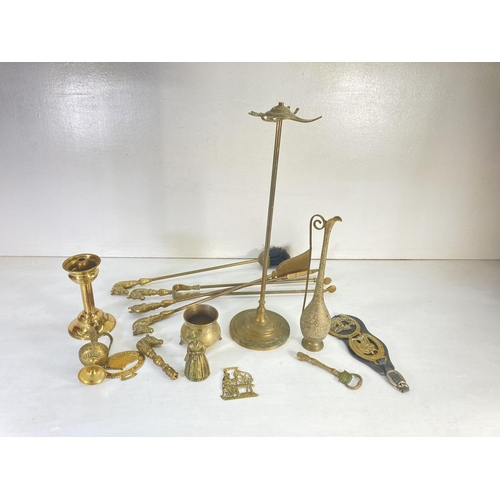 63 - A collection of assorted brassware to include two Middle Eastern style decanters, five piece fire co... 