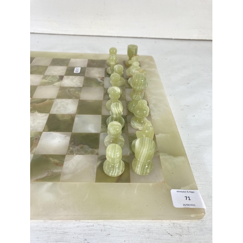 71 - An onyx thirty two piece chess set - board approx. 40.5cm²