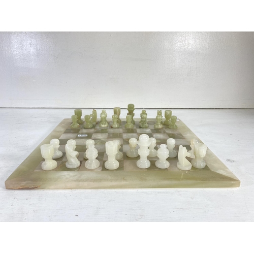 71 - An onyx thirty two piece chess set - board approx. 40.5cm²