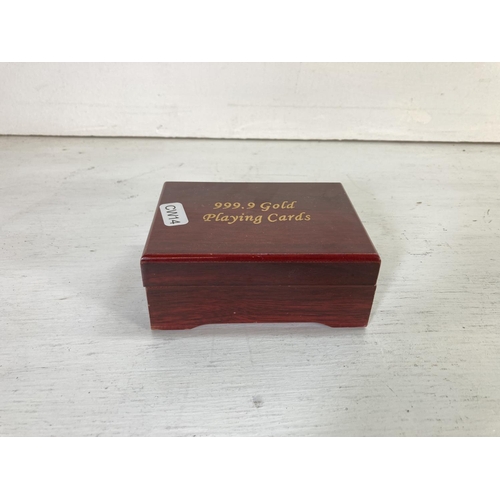 77 - A set of rosewood effect cased 99.9% pure 24ct gold foil playing cards