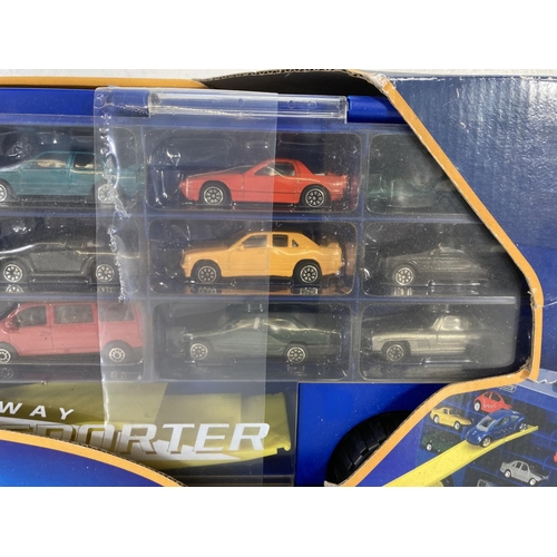 89 - A boxed Time 4 Toys Drive-Away Transporter artic truck with two loading ramps and 15 various diecast... 