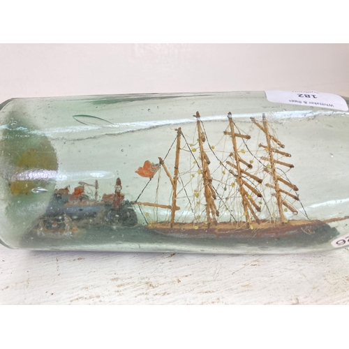 182 - A vintage scratch built ship in a bottle depicting a lighthouse scene - bottle approx. 36cm long