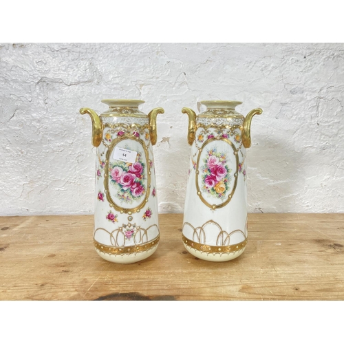 54 - A pair of Noritake hand painted porcelain twin handled vases with gilt decoration - approx. 30.5cm h... 