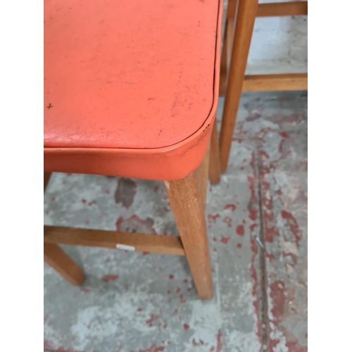 421 - Four mid 20th century orange vinyl and beech stools - approx. 48cm high x 30cm²