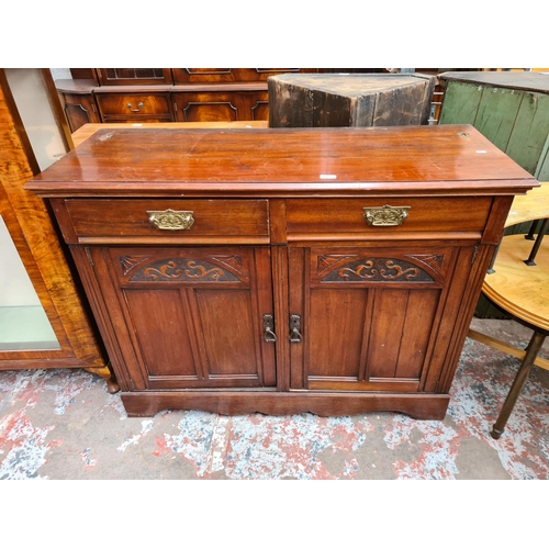 422 - An Edwardian mahogany sideboard with two drawers and two carved panel doors - approx. 93cm high x 12... 