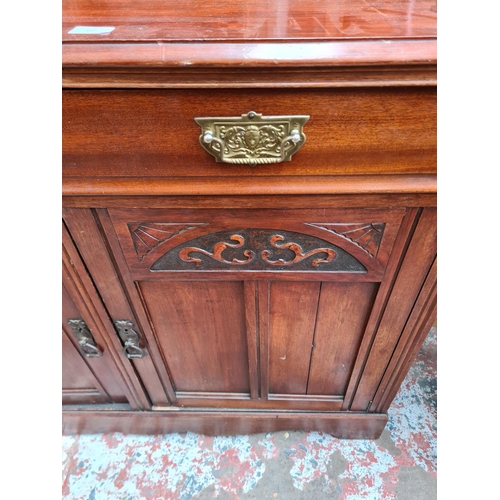 422 - An Edwardian mahogany sideboard with two drawers and two carved panel doors - approx. 93cm high x 12... 