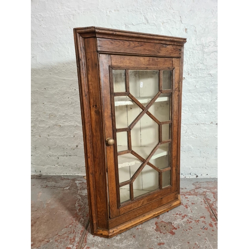 427 - A George III oak astral glazed wall mountable corner cabinet - approx. 99cm high x 64cm wide x 37cm ... 