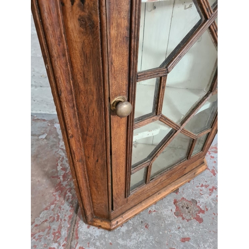 427 - A George III oak astral glazed wall mountable corner cabinet - approx. 99cm high x 64cm wide x 37cm ... 