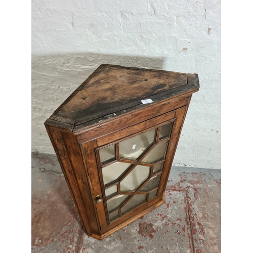 427 - A George III oak astral glazed wall mountable corner cabinet - approx. 99cm high x 64cm wide x 37cm ... 