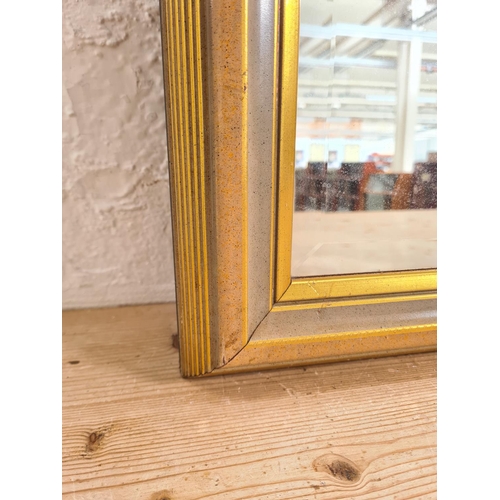 465 - A gilt framed bevelled edge wall hanging mirror - approx. 102cm wide x 72cm high