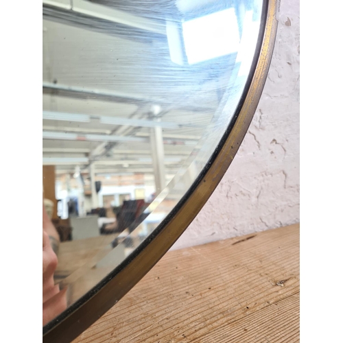 468A - A mid 20th century brass framed bevelled edge oval wall hanging mirror - approx. 65cm wide x 55cm hi... 