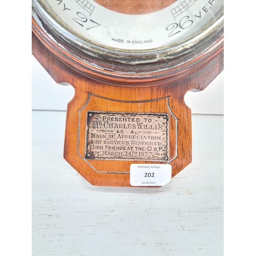 202 - An Art Deco walnut cased barometer with white metal presentation plaque inscribed 'Presented to Mr. ... 