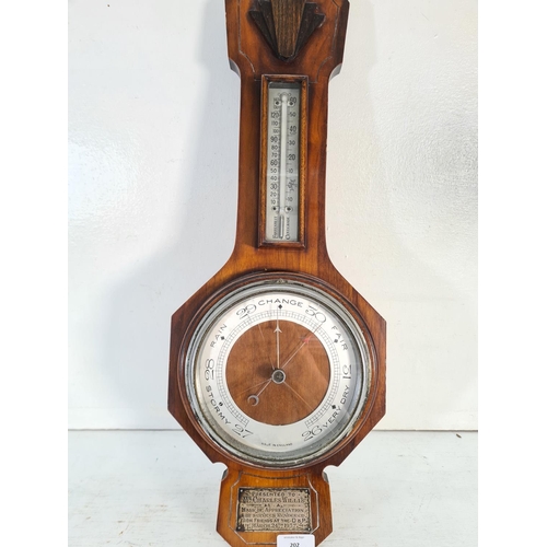 202 - An Art Deco walnut cased barometer with white metal presentation plaque inscribed 'Presented to Mr. ... 