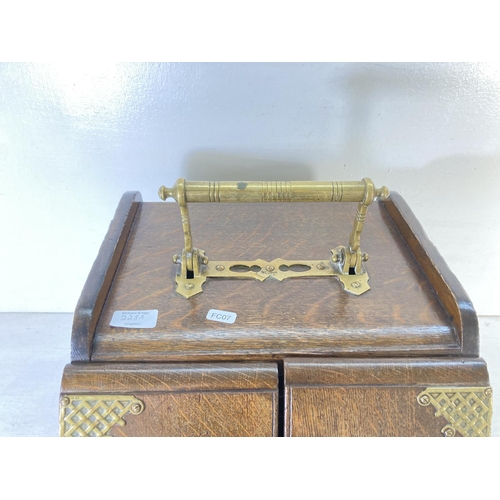 228A - An Edwardian oak coal scuttle with brass lever handle, two doors and tin liner - approx. 41cm high x... 